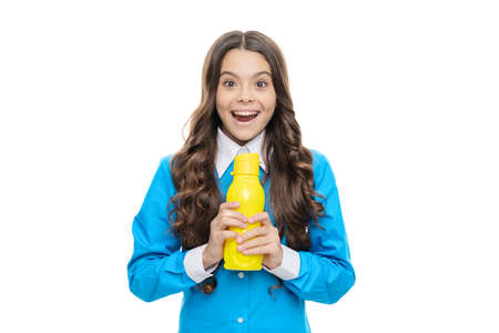 Happy child hold yellow plastic bottle with delicious refreshing beverage, pleasureの写真素材