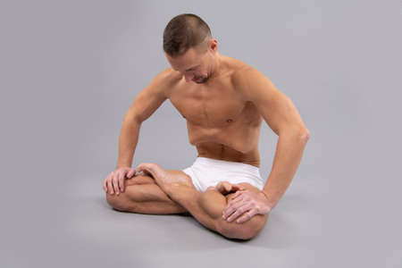 Seated in self. Athlete do lotus position. Full lotus. Cross legged sitting pose. Asana in yogaの写真素材