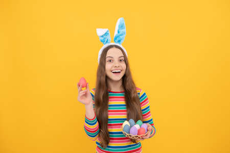 eastertide. time for fun. adorable funny kid on egg hunt. easter spring holiday. happy teen girlの写真素材