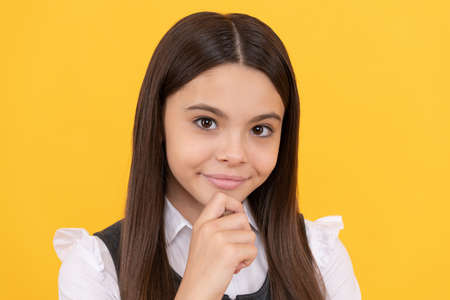 School girl child face yellow background, portraitの写真素材