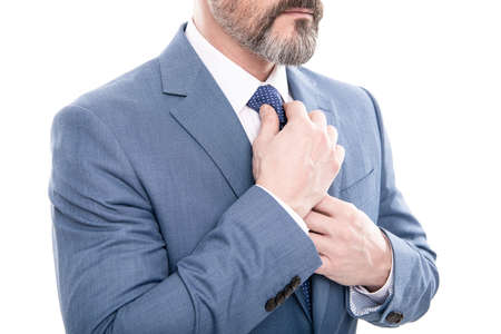 all should be perfect. cropped boss straighten tie. mature businessman in formalwear.
