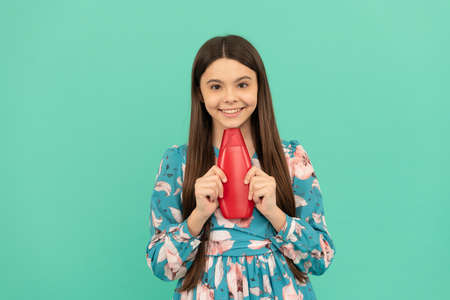 happy child with long hair hold shampoo bottle, beautyの写真素材