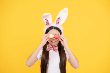 Feeling joy. smiling teenage girl in bow tie. bunny egg hunt. just having fun. ready for party.の写真素材