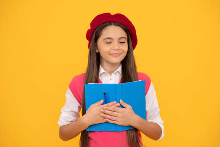 childhood happiness. back to school. dreamy kid in beret ready to study. smiling child making notes