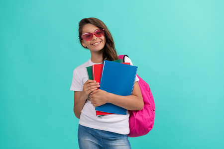 happy kid with backpack and copybook in sunglasses ready to study at school, back to schoolの写真素材