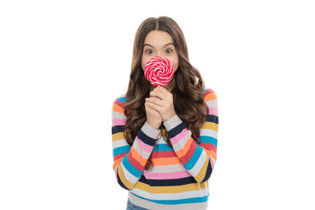 cheerful child in sweater with lollipop candy on stick isolated on white background, dental care.の写真素材