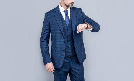 confident businessman look at time. business success. successful man in businesslike suitの写真素材