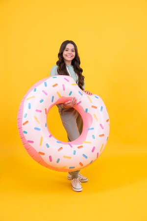 lets swim. teen with swimming ring. child holding beach accessory of inflatable circle. active childhood. summertime kid weekend. summer vacation. happy girl in sportswear hold inflatable ring.の写真素材