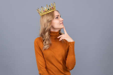 thoughtful blonde woman in crown. arrogance and selfishness. portrait of glory.の写真素材