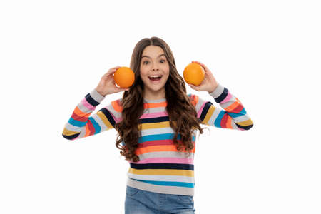 surprised child in colorful sweater with orange fruit isolated on white, surpriseの写真素材