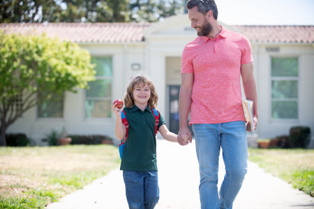 education. first day at school. father and son come back from school. happy family value.の写真素材