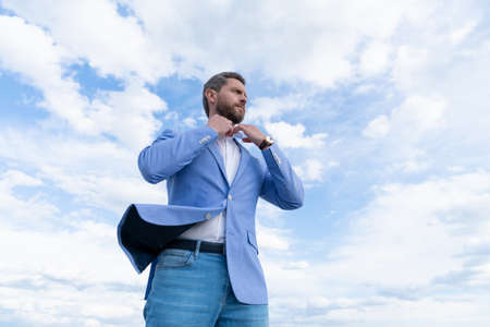 male formal fashion. professional unshaven ceo. man bride groom on sky background.の写真素材