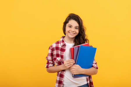 smiling school child ready to study with copybooks, knowledgeの写真素材