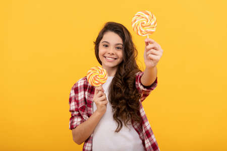 sweet childhood life. teen dental care. sweet tooth. yummy. happy girl hold lollipop. lollipop childの写真素材