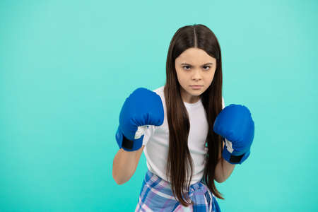 concentrated kid boxer punching in boxing gloves during sport training, copy space, determinationの写真素材