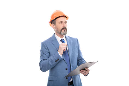 successful man in hardhat making notes. entrepreneur read project. ceo with construction documentsの写真素材