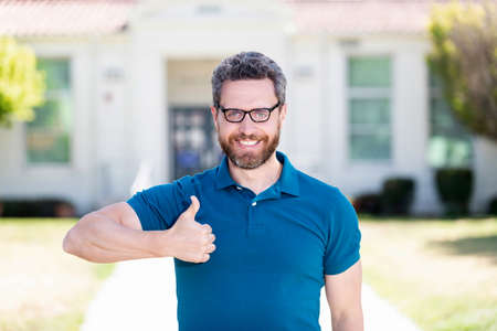 good eye health of happy guy in glasses with thumb up gesture, eye careの写真素材