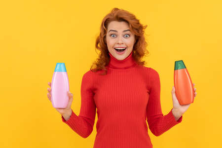daily habits and personal care. redhead lady presenting cosmetic product.の写真素材
