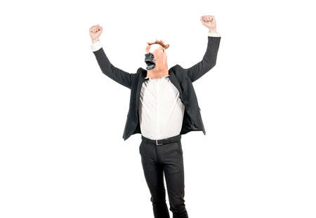 Hard work spells success. Businessman wear horse head mask with raised arms. Enjoying successの写真素材