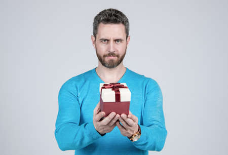 successful guy holding giftbox. handsome man prepare for romance date. man with business rewardの写真素材
