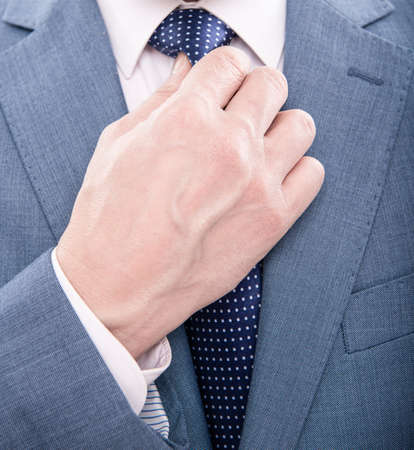 hand tie necktie of man in suit closeup, formal fashionの写真素材