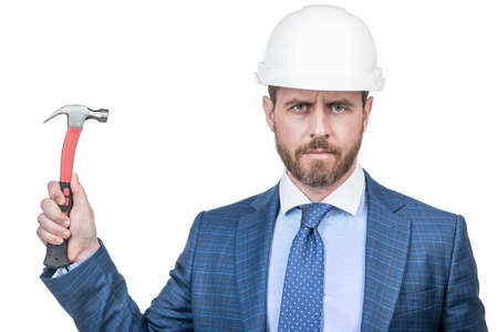 confident businessman man in suit and safety helmet hold hammer isolated on white, supervisorの写真素材