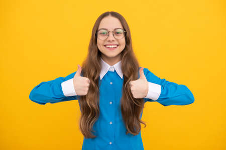 Get education, get satisfaction. Happy teen girl give thumbs ups. Satisfaction hand gesture. Be satisfiedの写真素材