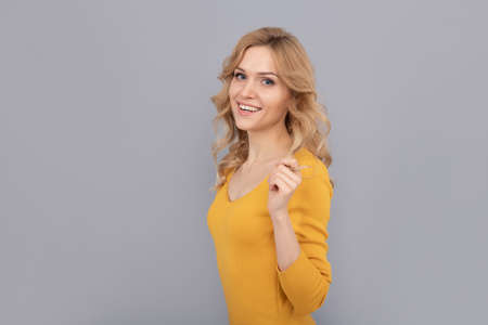 cheerful blonde beauty woman touch curly hair, copy space, hairdresserの写真素材