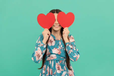 smiling child hold red heart symbol of love for valentines day, valentineの写真素材