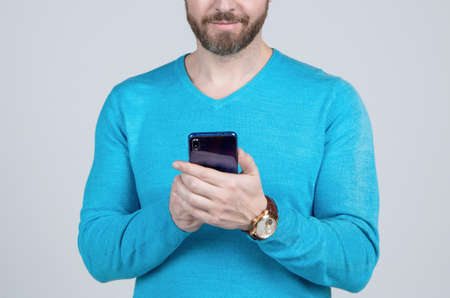 cropped man with beard chatting online on smartphone, communicationの写真素材