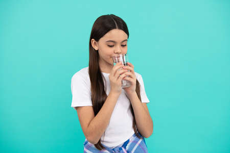 drinking per day. hydration vitality. be hydrated. kid hold glass of mineral water.の写真素材