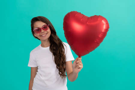 sweetheart. valentines sale. portrait of child with heart balloon. happy valentines dayの写真素材