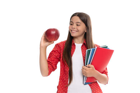 happy child hold school copybook for studying and apple lunch isolated on white, back to schoolの写真素材