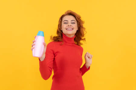 girl curly hair offer shampoo bottle. hair conditioner advertisement. beauty product.の写真素材
