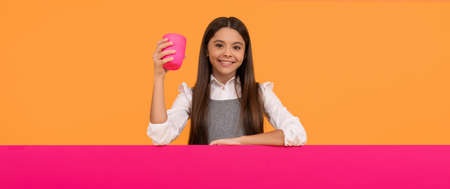 Happy kid hold plastic cup with drink and placard for copy space, beverage advertisingの写真素材