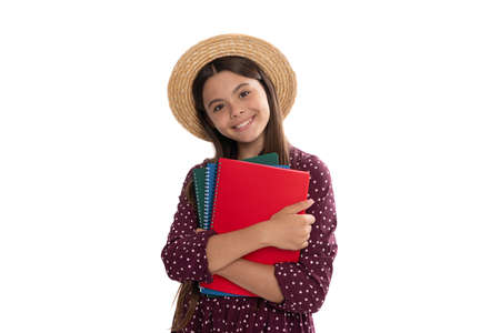 happy cute teen girl in straw hat hold school workbook for studying isolated on white, high schoolの写真素材