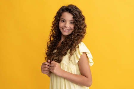 happy kid with long curly hair and perfect skin, beautyの写真素材