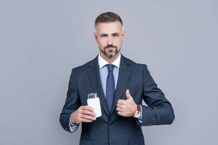 businessman taking medicine pills. drug business. successful man employee take meds.の写真素材