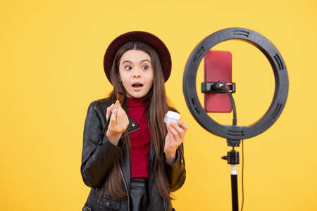 blogging ring lamp. weblog and vlog. makeup tutorial. influencer. amazed teen girl use selfie led.の写真素材