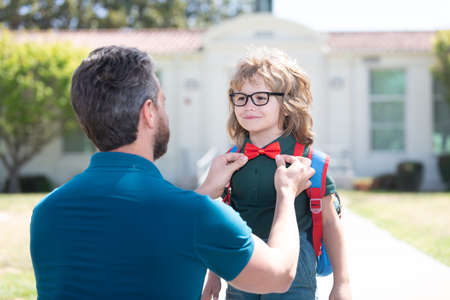 father and son come back from school. happy family value. childhood and parenthood.の写真素材