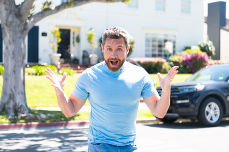 happy unshaven man with amazed face gesturing in feeling of amazement, surpriseの写真素材