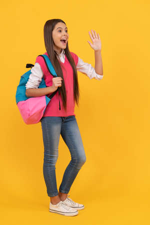 hello. happy teen girl carry backpack. childhood happiness. back to school.の写真素材