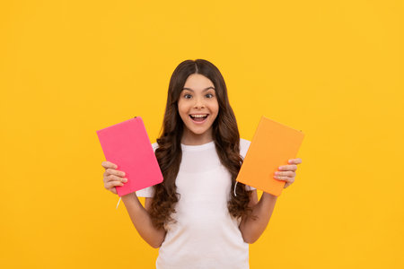 teen girl with book. kid planning her study. student prepare for exam. schoolgirl do homeworkの写真素材