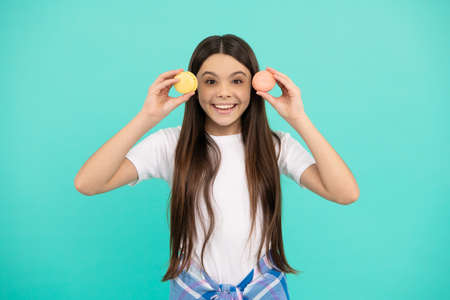 happy kid hold french macaron or macaroon cookies, happinessの写真素材