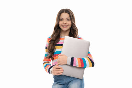 school blogger hold computer. kid ready for lesson isolated on white. girl use laptopの写真素材