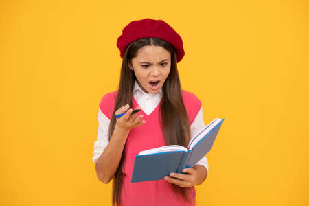 feeling shock. shocked french teen girl hold notebook. childhood happinessの写真素材