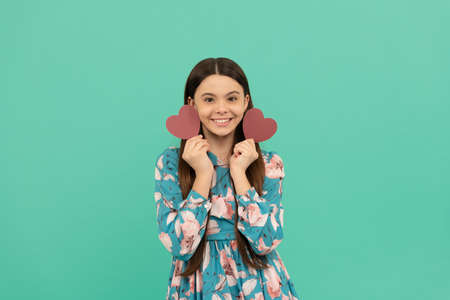 cheerful teen girl hold red heart symbol of love for valentines day, valentines dayの写真素材
