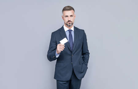 businessman demonstrating credit or debit card. empty plastic business name card.の写真素材