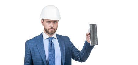 engineer in hardhat with spatula. renewal and repairs. confident businessman in suit, copy spaceの写真素材
