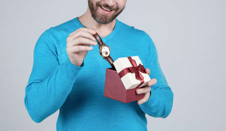 occasion greeting. guy showing gift box. corporate present. male fashion accessory.